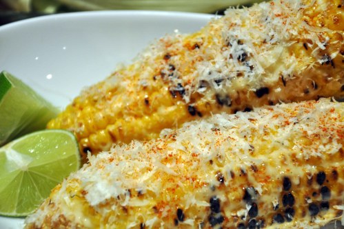 Grilled corn with mayonnaise, chili powder, cotija cheese and a dash of lime