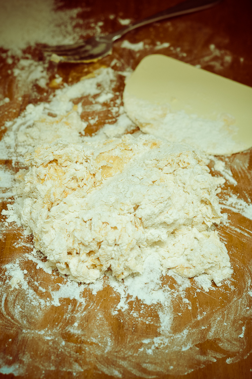 Using a pastry scraper, gather the dough into a ball